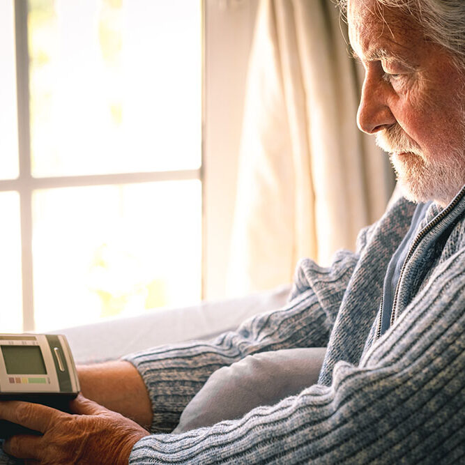 senior-bearded-man-using-medical-device
